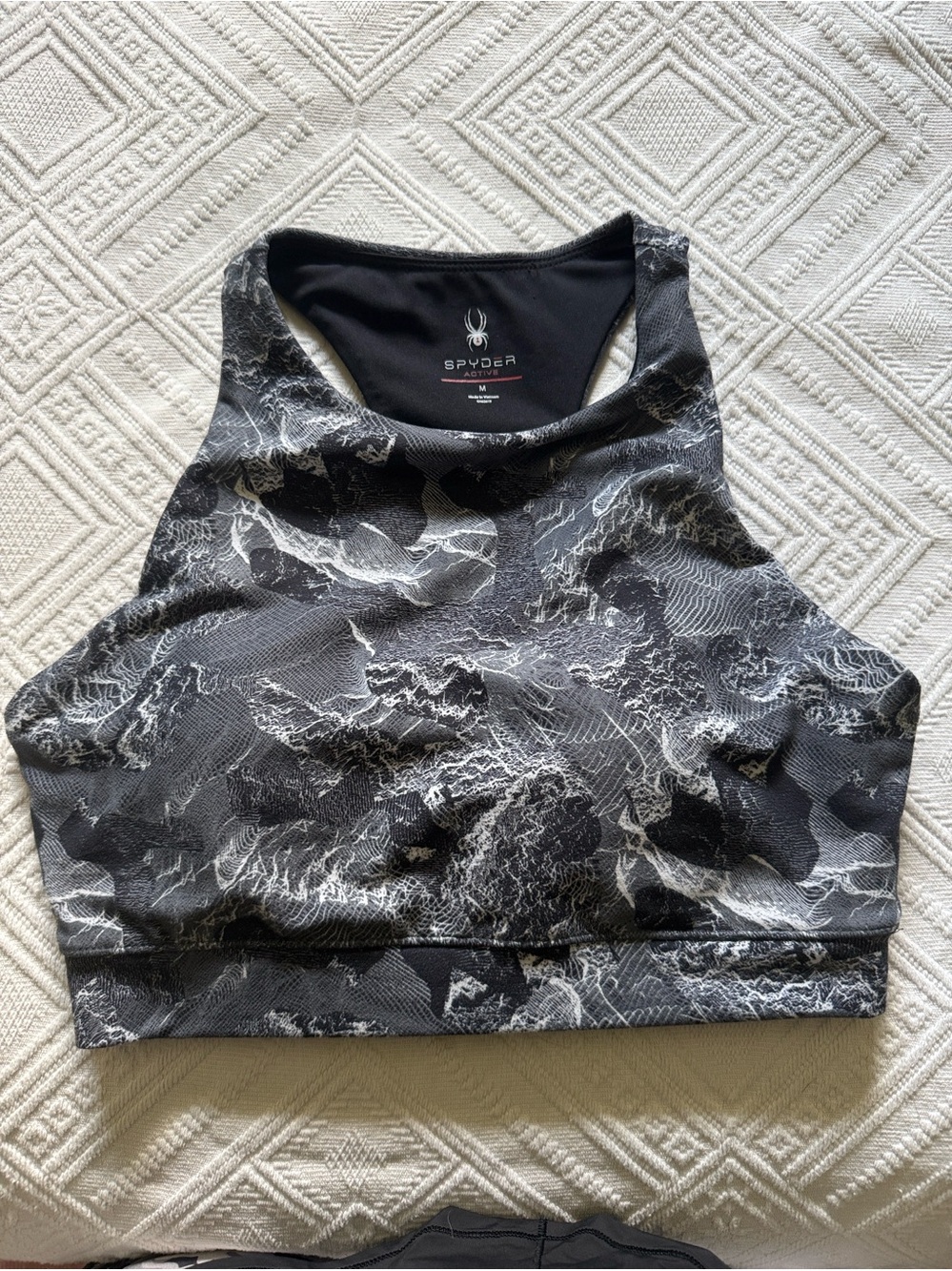Spyder Active brand high-neck sports bra detailed monochrome textured print